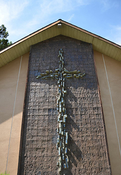 Rugged mosaic cross on the outside of our building